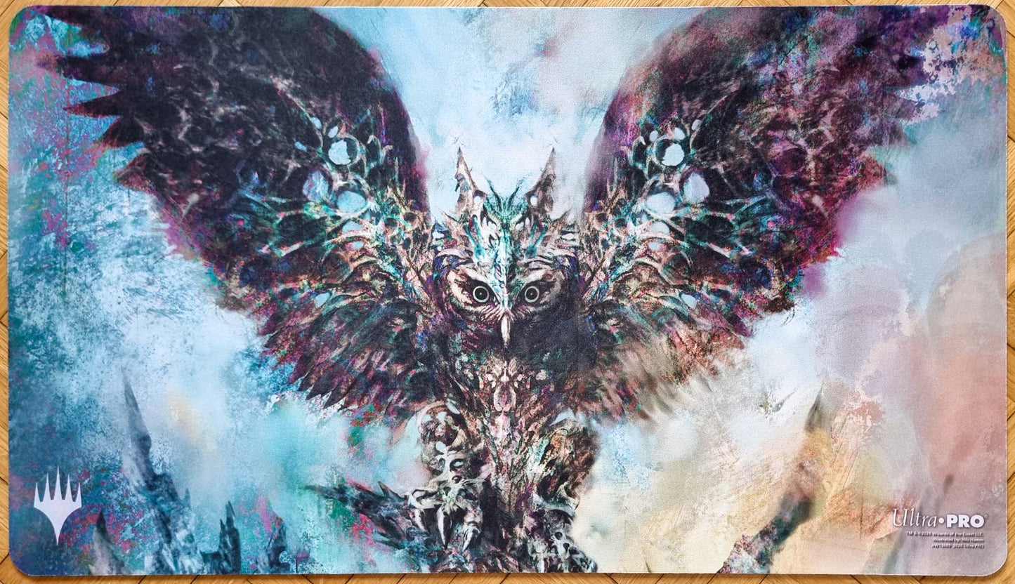 Baleful Strix MTG playmat by Nils Hamm featuring the white Magic logo, with an eerie owl construct spreading its wings in icy blue abstract artwork.