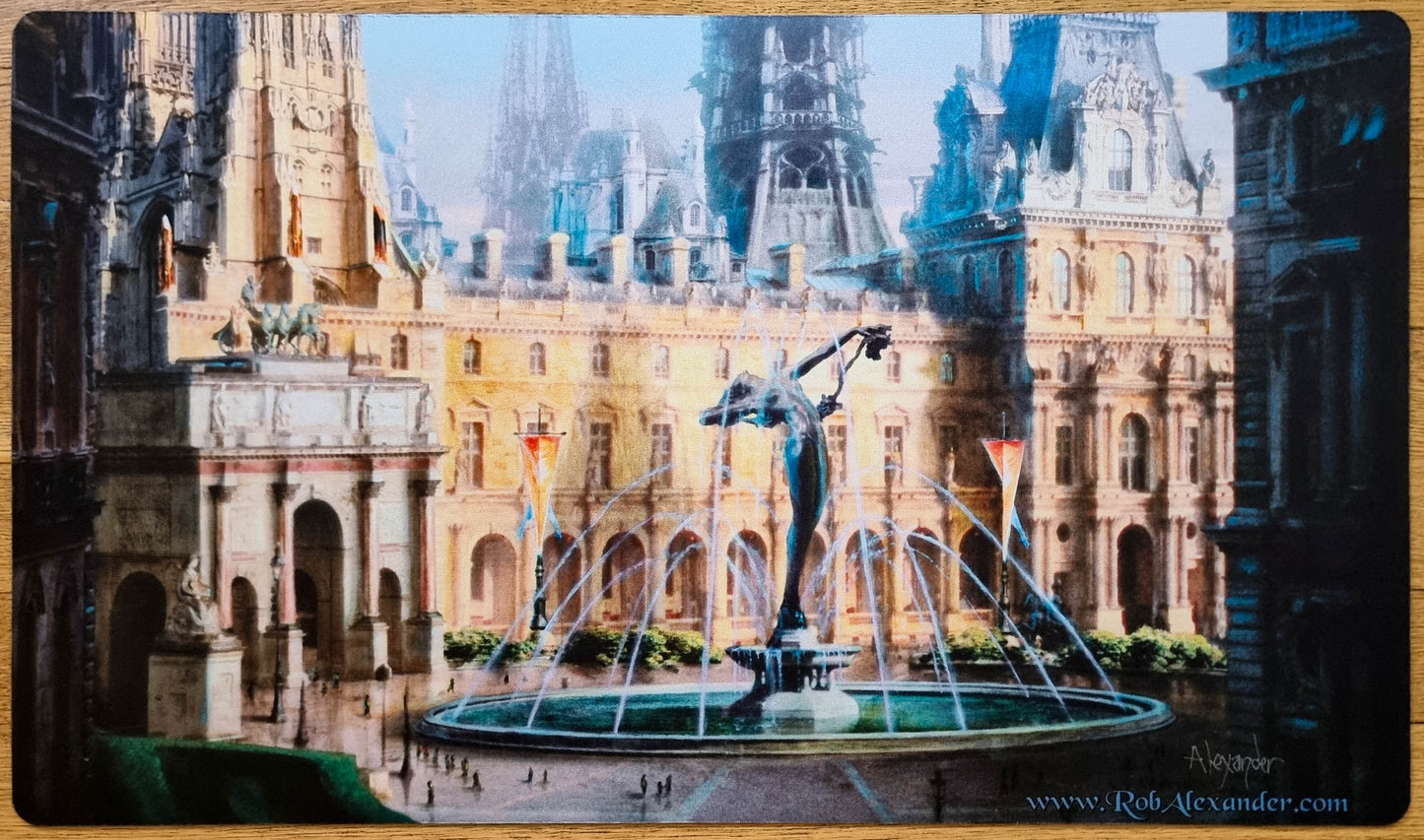 Signed Hallowed Fountain MTG playmat by Rob Alexander showing a grand fountain courtyard surrounded by ornate Ravnica-style city architecture.