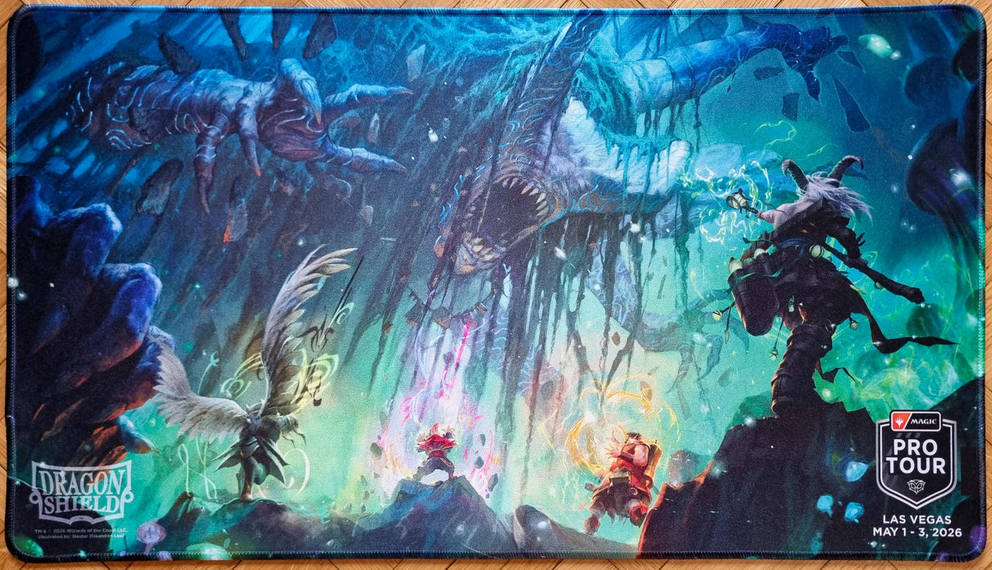 Together as One MTG playmat by Néstor Ossandón Leal for Pro Tour Las Vegas 2026, showing spellcasters facing a huge cavern monster with Dragon Shield and Pro Tour logos.