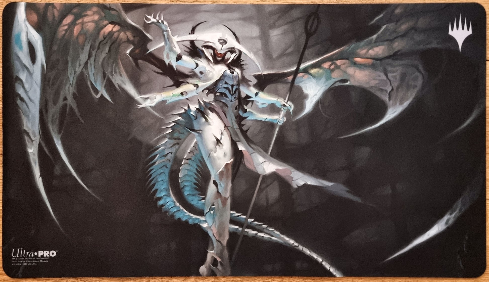 Atraxa, Praetors’ Voice MTG playmat by Victor Adame Minguez featuring a dark winged Phyrexian figure against a shadowed background.