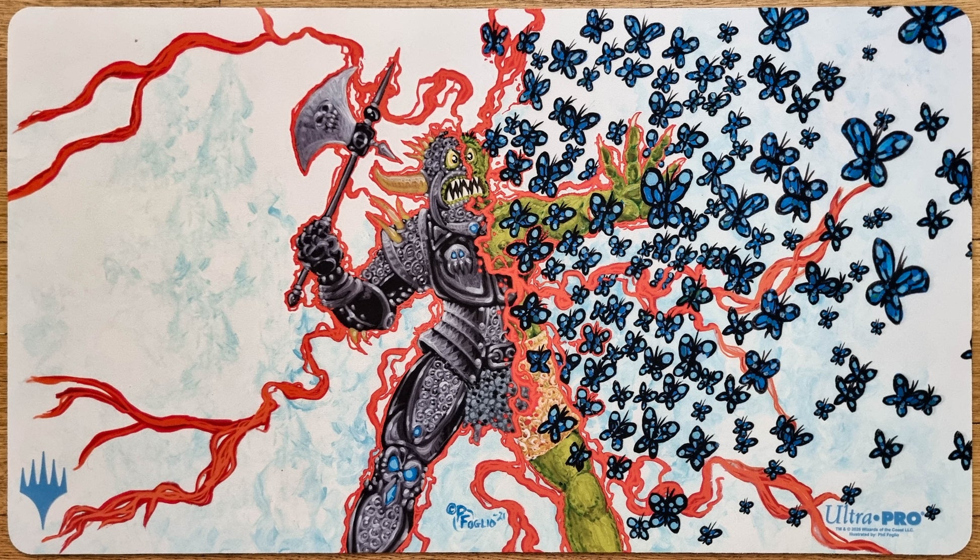 Chaos Warp MTG playmat by Phil Foglio showing a chaotic figure transforming into blue butterflies amid twisting red magical energy.
