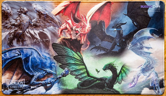 MagicCon Amsterdam 2026 Dragon Shield playmat featuring six mascot dragons across red, blue, green, black, white and icy elemental scenes, with stitched edges.
