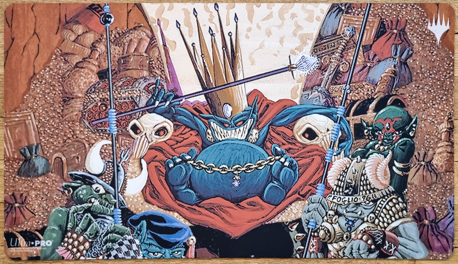 Goblin King MTG playmat by Phil Foglio showing a crowned goblin ruler surrounded by goblins, spears, treasure, and chaotic court details.