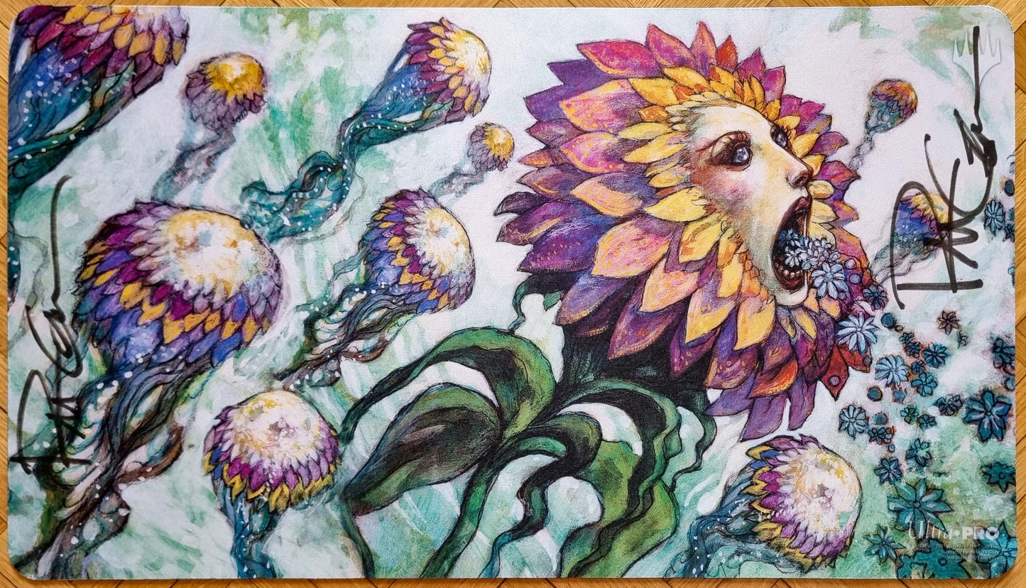 Signed Hana Kami MTG playmat featuring Rebecca Guay’s Champions of Kamigawa artwork, showing a colorful flower spirit surrounded by curling plants and blossoms.