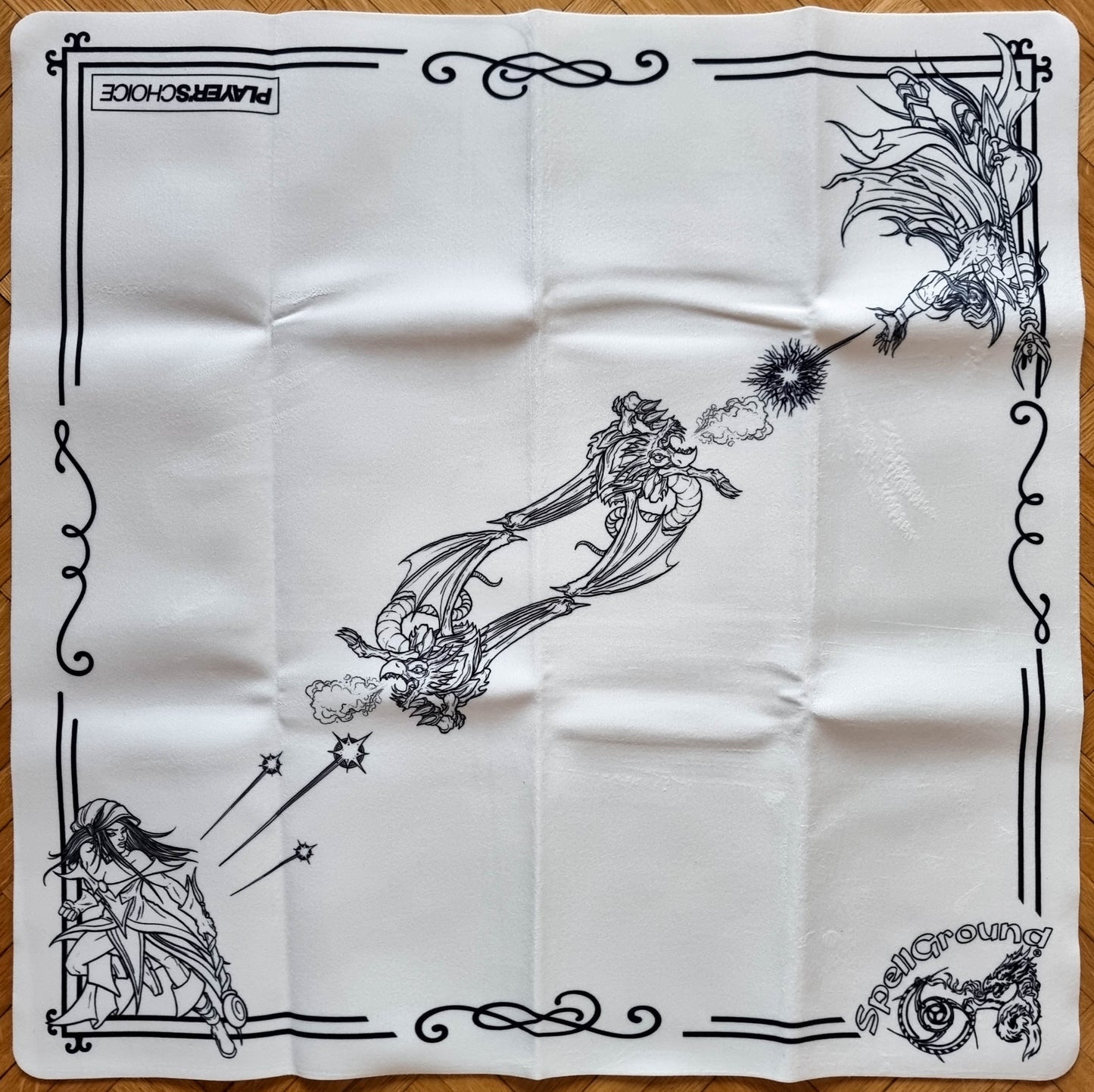 White SpellGround Dark Mages 2-player playmat from the Khalsa Brain Games and Player’s Choice collaboration, with black fantasy line art, mages, dragons, and ornamental borders.