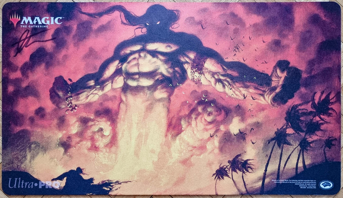 Signed Mahamoti Djinn MTG playmat featuring Greg Staples’s Ninth Edition artwork, showing a towering djinn rising through glowing purple clouds above dark silhouettes.