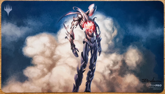 Signed Solemn Simulacrum MTG playmat by Dan Murayama Scott showing a metallic artifact figure with a glowing red eye standing above clouds.