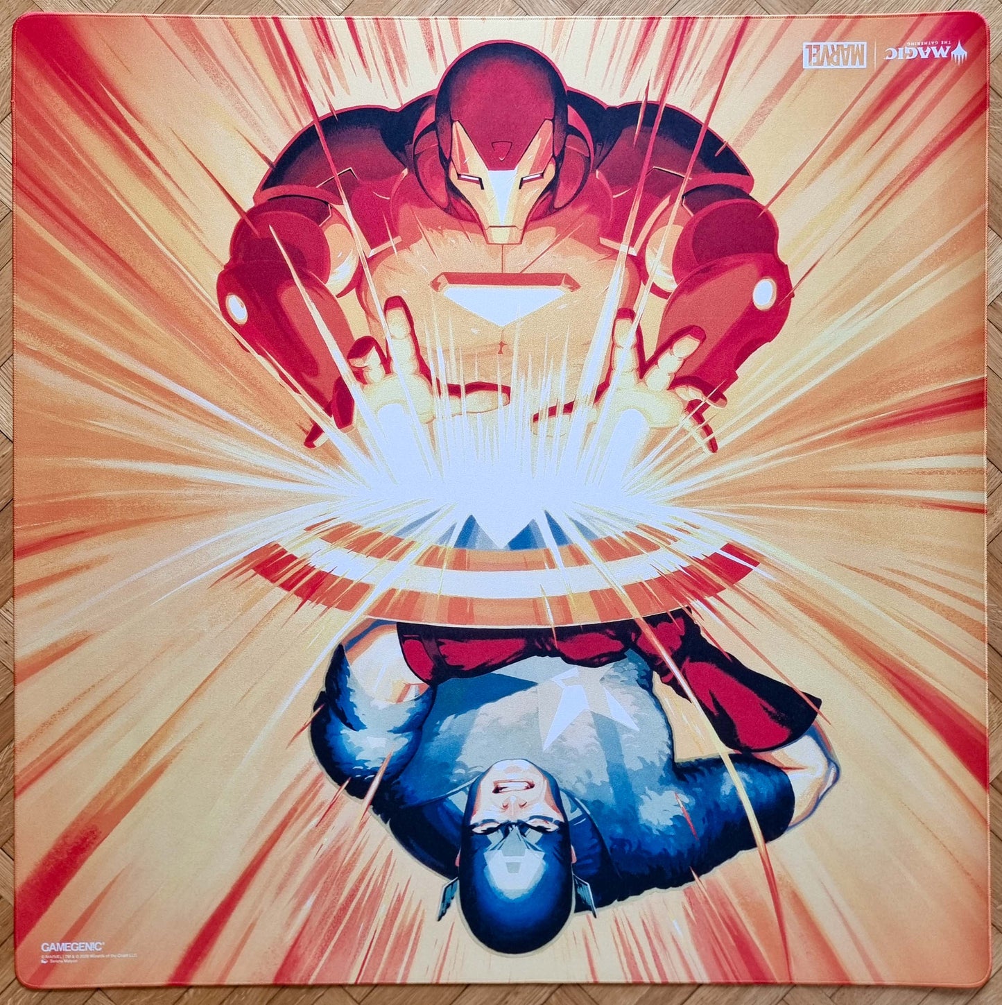2-player Marvel Super Heroes stitched playmat featuring The Super Hero Civil War by Serena Malyon, showing Iron Man and Captain America colliding around a bright central burst of energy.