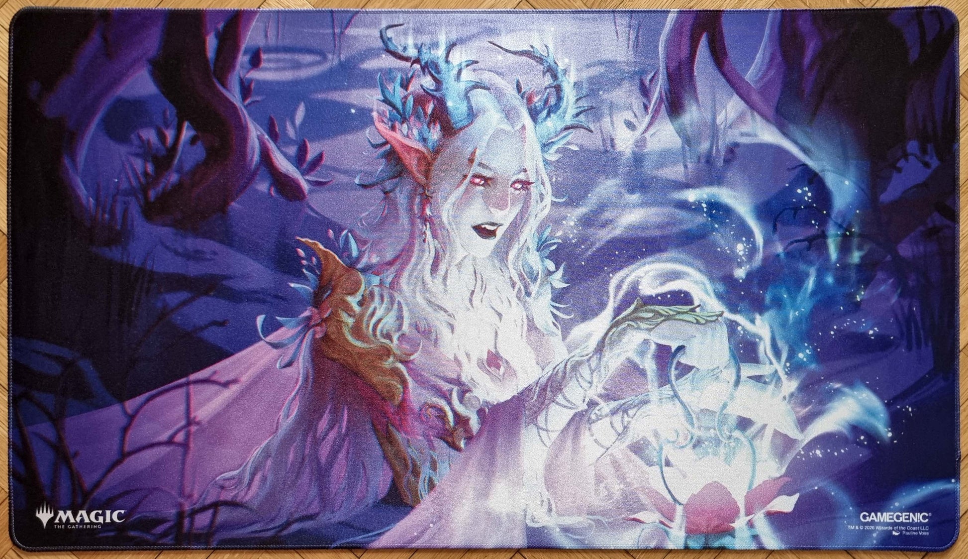 Twilight Diviner stitched MTG playmat by Pauline Voss showing an ethereal spellcaster surrounded by glowing magic in a purple-blue forest scene.