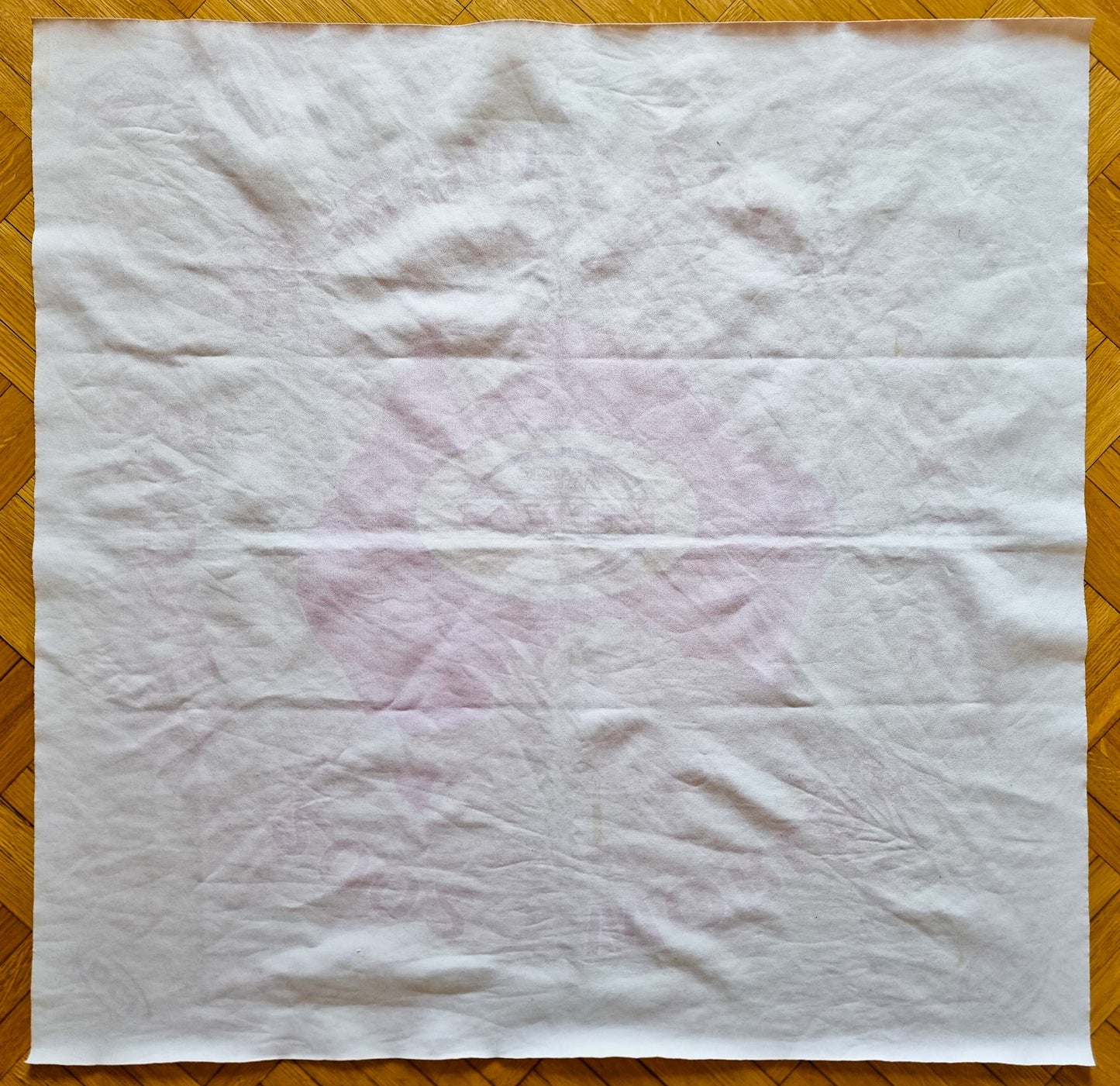 Plain white reverse of the 2002 World Championships Sydney cloth playmat, with the magenta Australia design faintly visible through the thin woven fabric.