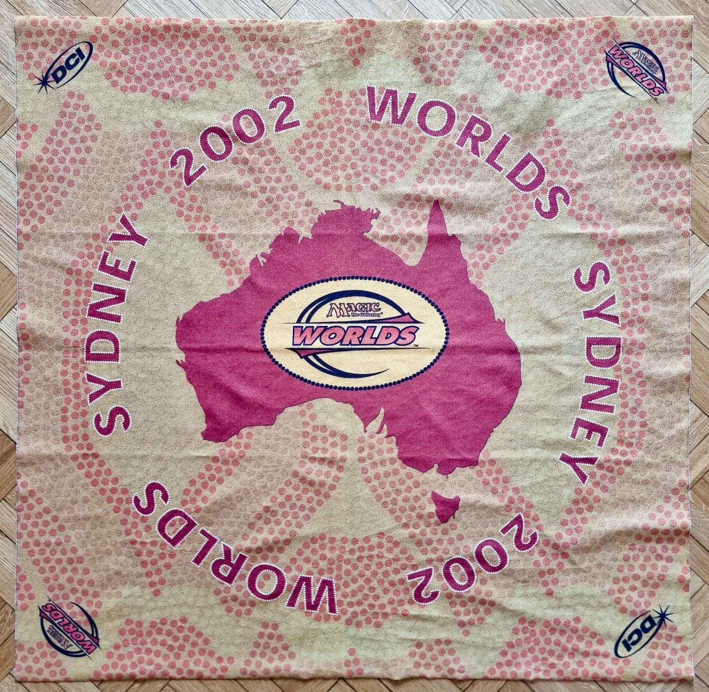 2002 Magic World Championships Sydney square cloth playmat featuring a magenta map of Australia, Worlds and DCI logos, and pink dot-pattern graphics.