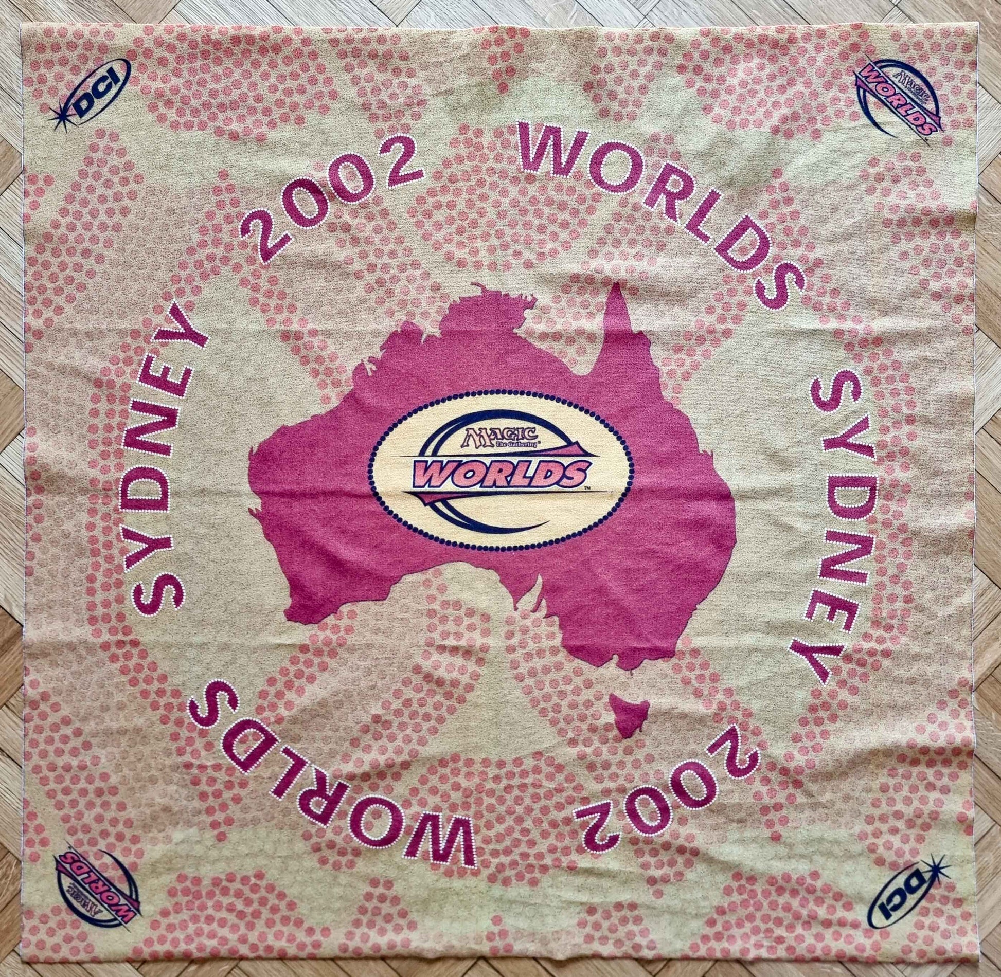 2002 Magic World Championships Sydney square cloth playmat featuring a magenta map of Australia, Worlds and DCI logos, and pink dot-pattern graphics.